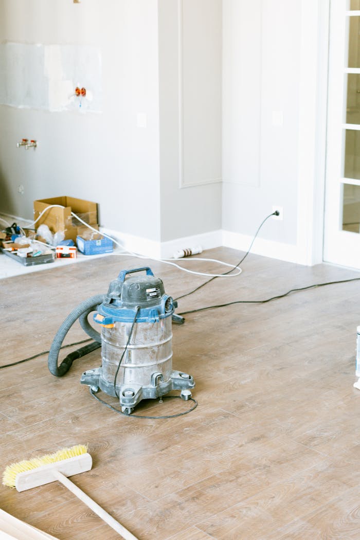 gallery-3 Vacuum and tools in a room undergoing renovation, showcasing home improvement.
