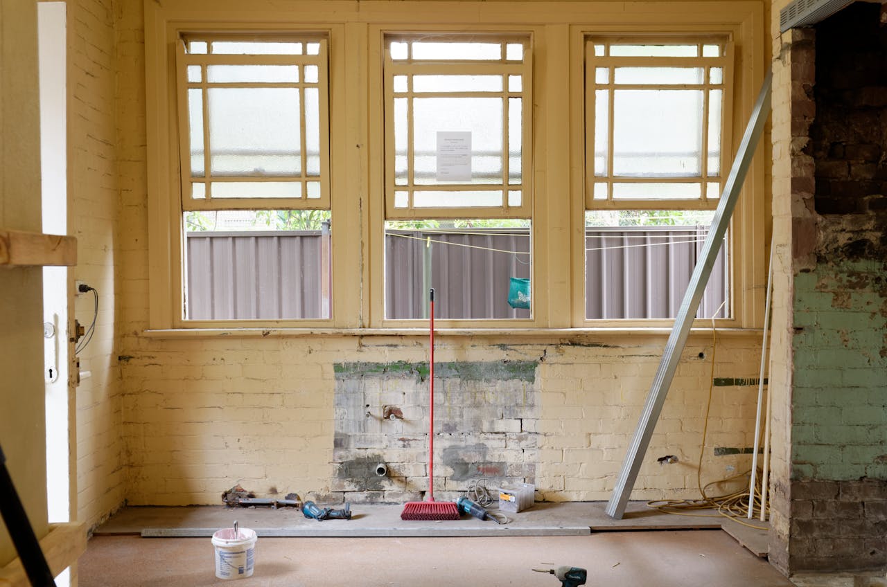 our-services-3 An empty room featuring large windows, ready for renovation in Sydney, Australia.